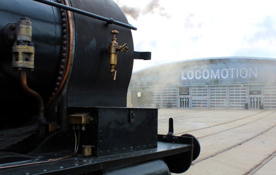 A locomotive in front of the Collection Building